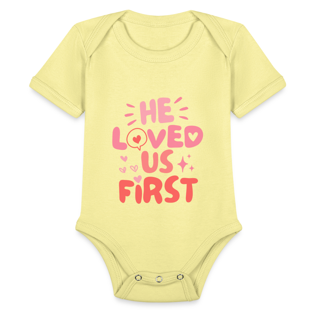 He Loved Us First (Pink) Baby Onesie Bodysuit - washed yellow